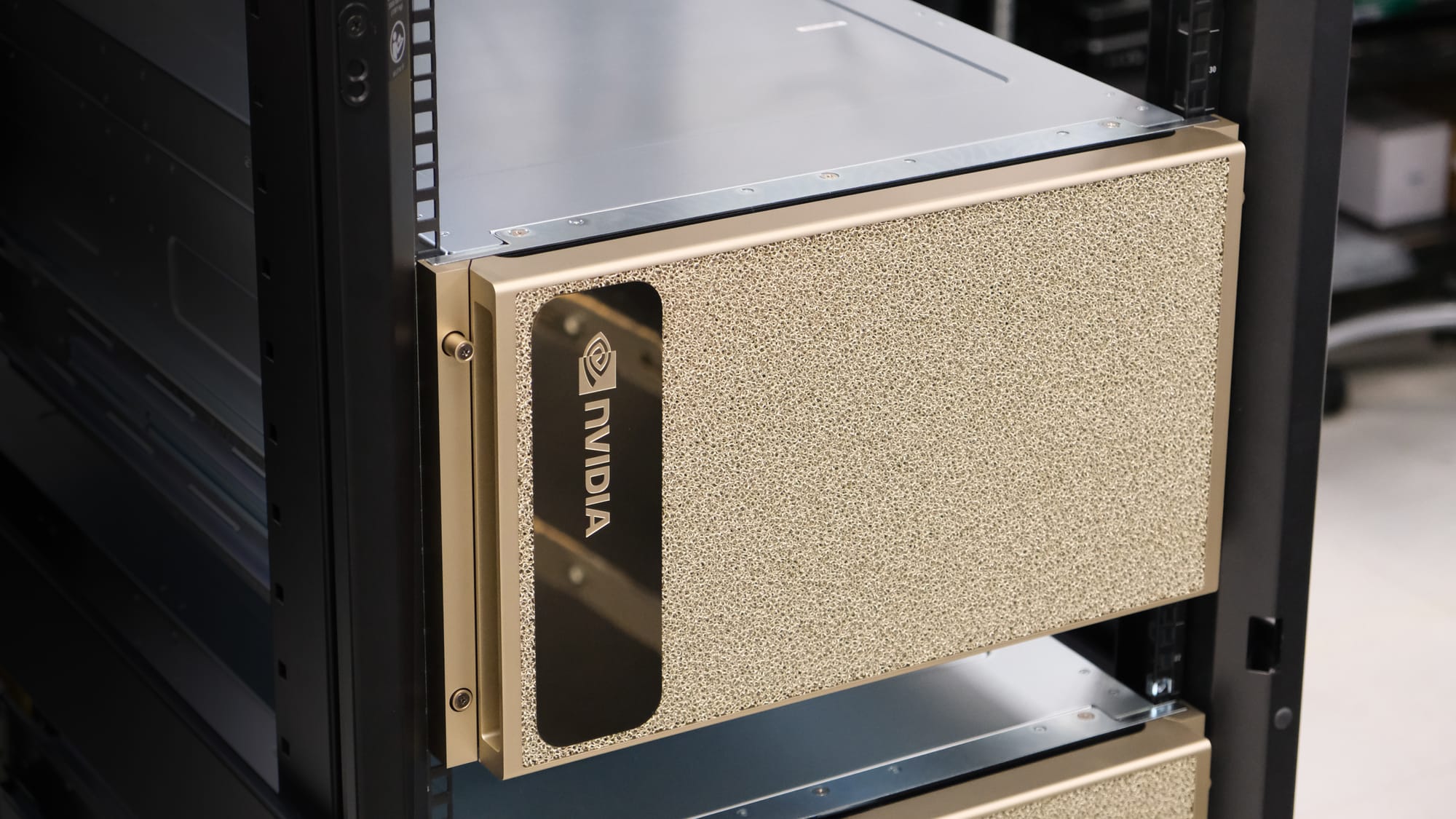 NVIDIA-branded gold-colored server unit installed in a black server rack, indicating high-performance computing or data center hardware.